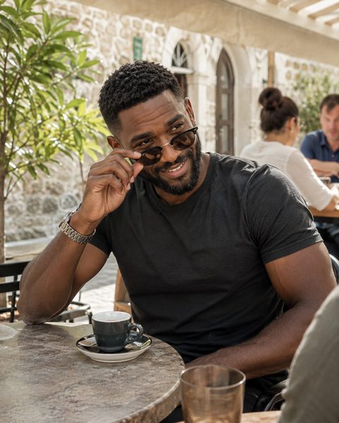 A relaxed cafe portrait illustrating a natural friend-taken dating photo
